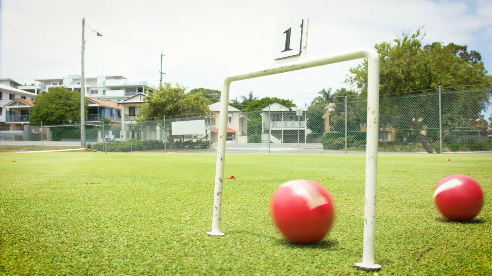 A red ball rolling past hoop one