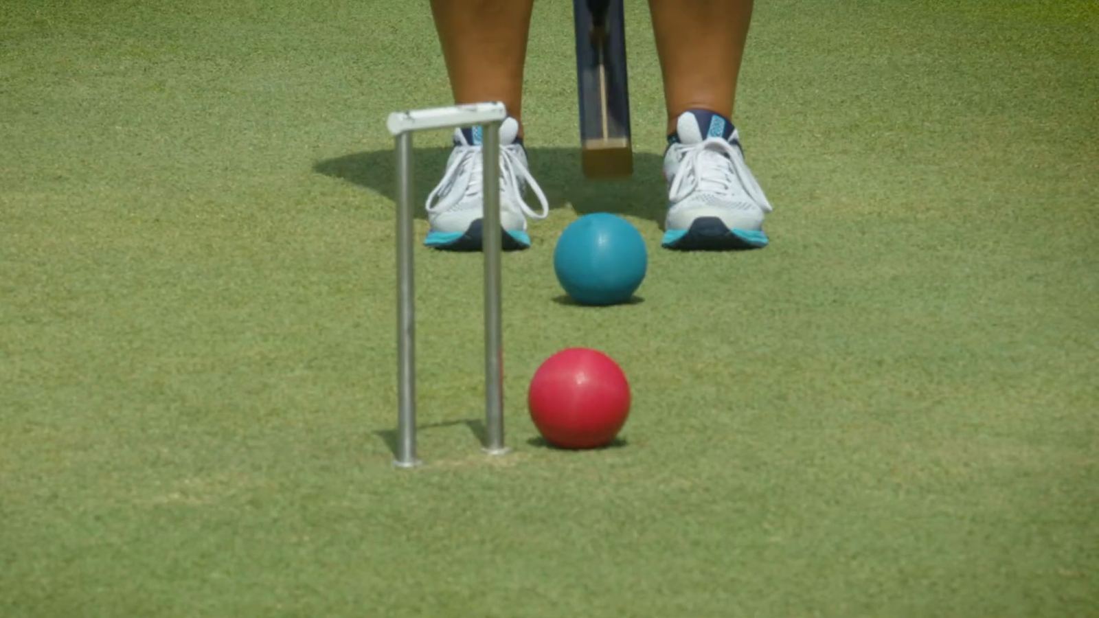 Teal and red balls at a hoop